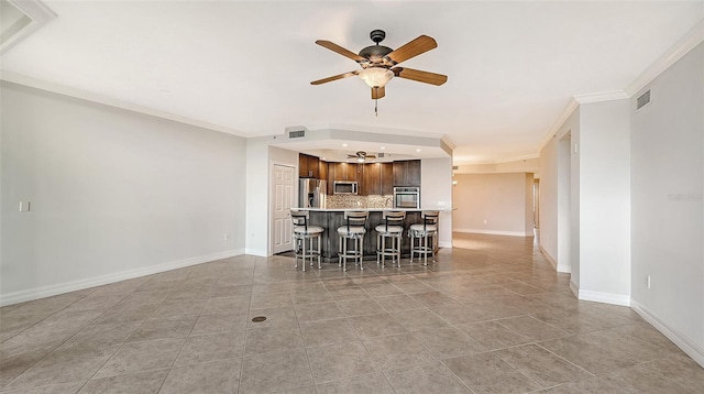 interior space featuring ornamental molding, ceiling fan, and tile flooring