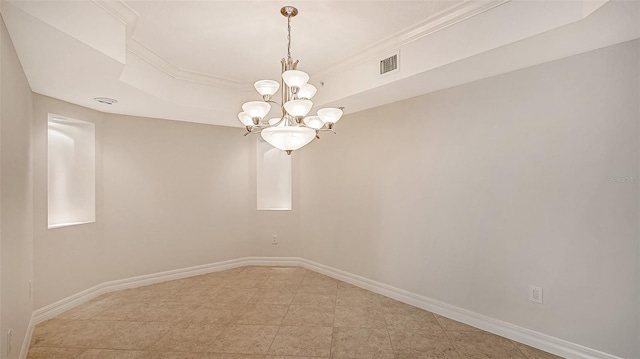 tiled empty room with a raised ceiling, crown molding, and a notable chandelier