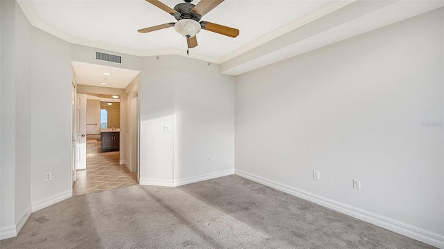 carpeted empty room featuring crown molding and ceiling fan