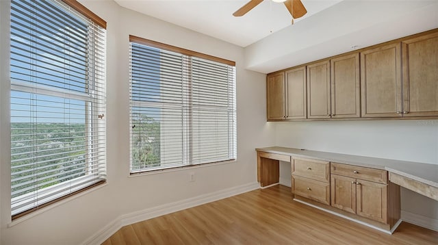 interior space with light hardwood / wood-style floors, ceiling fan, and built in desk