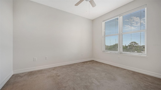 carpeted spare room with ceiling fan