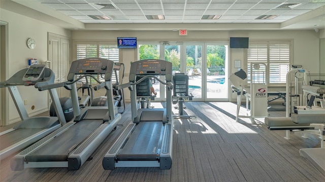 gym with a paneled ceiling