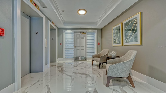 hall featuring light tile floors, a tray ceiling, and elevator