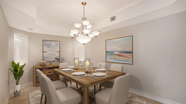 dining room with a chandelier and a raised ceiling