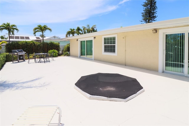 view of swimming pool featuring a patio area and grilling area