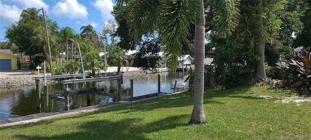 view of dock featuring a water view and a lawn