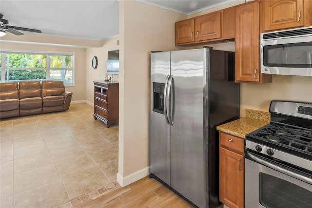 kitchen with ceiling fan, light hardwood / wood-style floors, appliances with stainless steel finishes, and ornamental molding