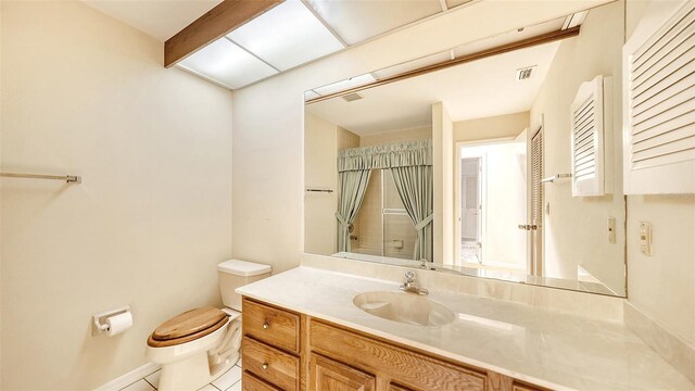 bathroom with tile patterned flooring, toilet, and vanity