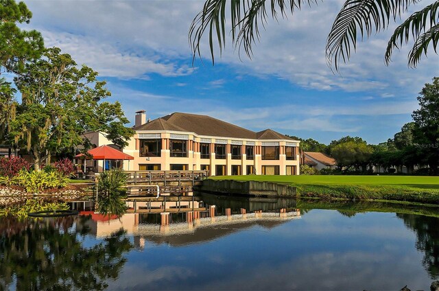 rear view of property with a water view