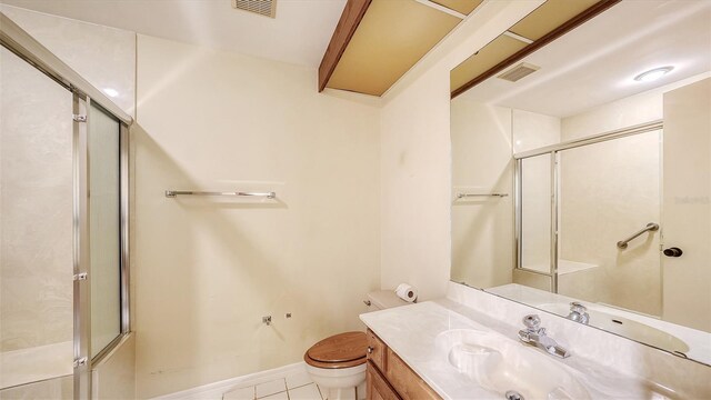 bathroom with tile patterned flooring, vanity, toilet, and walk in shower