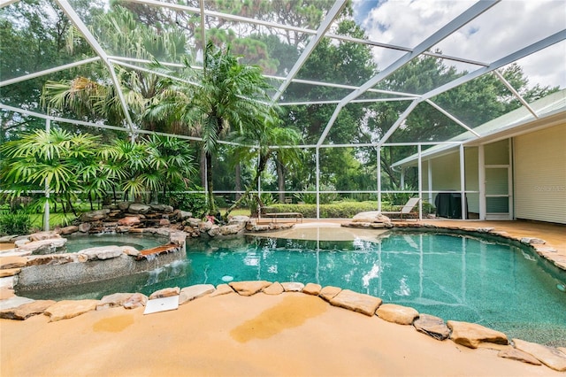 view of pool with an in ground hot tub and glass enclosure