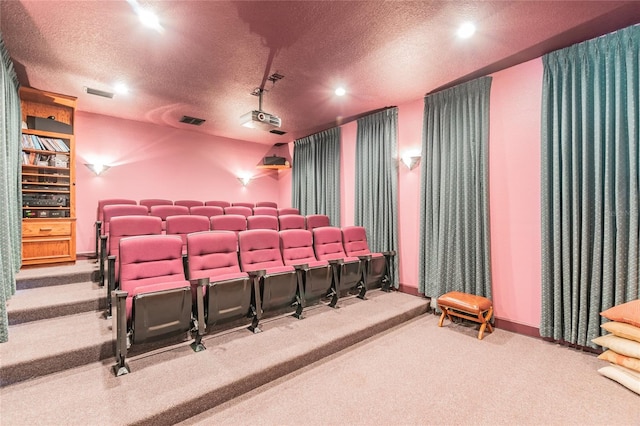 cinema featuring light colored carpet and a textured ceiling