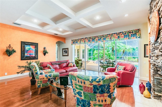 living room featuring coffered ceiling and light hardwood / wood-style floors