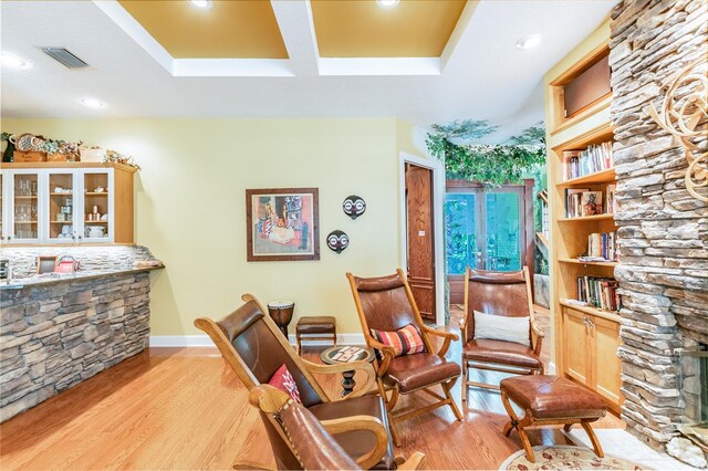 living area with light hardwood / wood-style floors and a fireplace