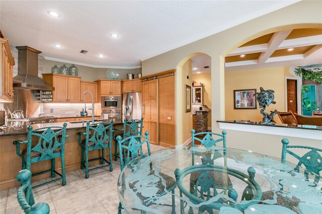 interior space featuring crown molding, sink, beam ceiling, and coffered ceiling