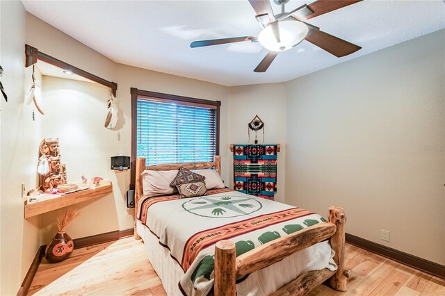 bedroom featuring light hardwood / wood-style floors and ceiling fan