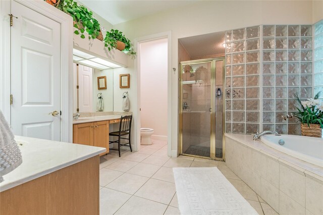 full bathroom featuring toilet, tile flooring, separate shower and tub, and vanity