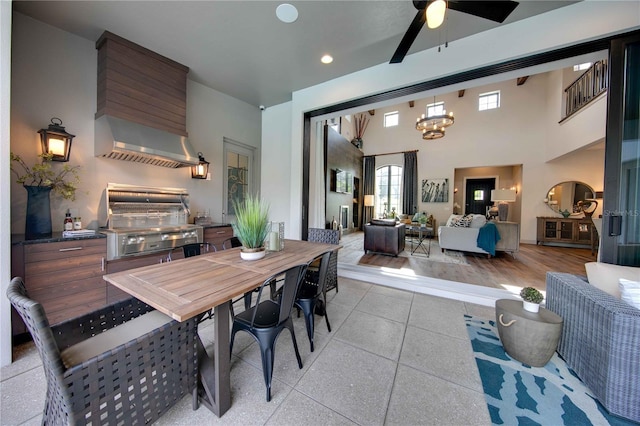 dining area featuring light hardwood / wood-style floors and ceiling fan with notable chandelier