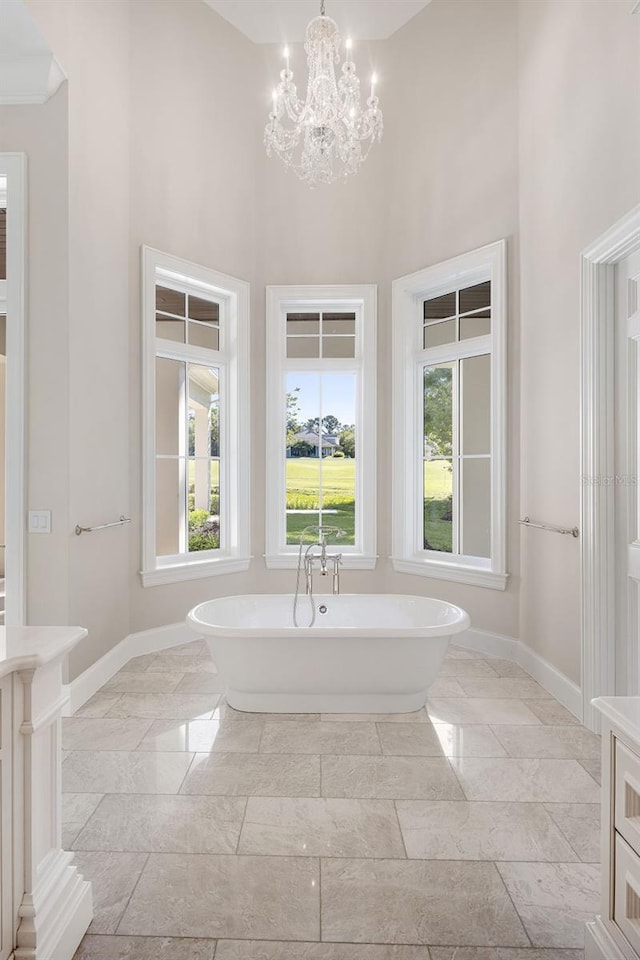 bathroom featuring a chandelier, tile floors, vanity, and a high ceiling