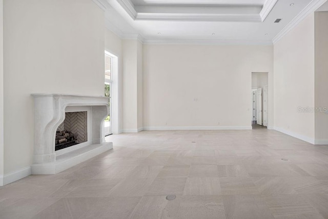 unfurnished living room with crown molding, light tile floors, and a tray ceiling