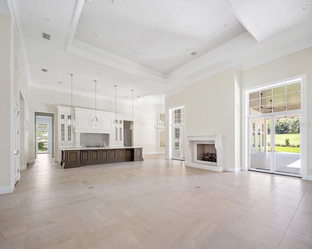 unfurnished living room featuring a high ceiling, light tile flooring, and a raised ceiling