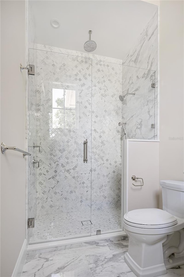 bathroom with a shower with shower door, toilet, and tile flooring