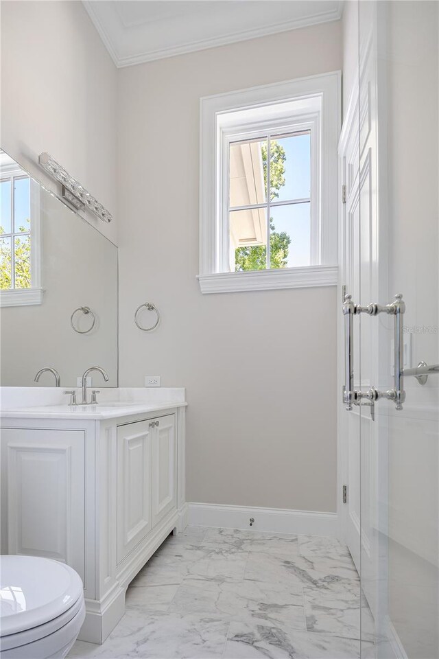 bathroom with vanity, tile floors, toilet, and crown molding