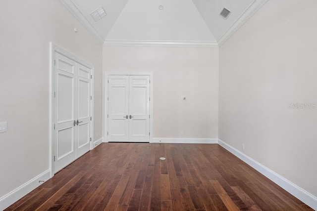 spare room with high vaulted ceiling, wood-type flooring, and crown molding