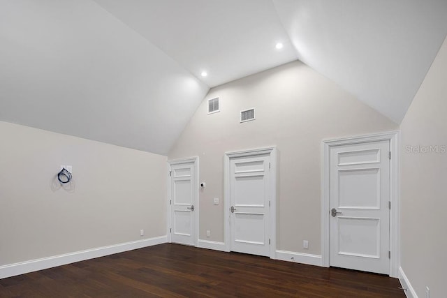 additional living space featuring dark hardwood / wood-style flooring and high vaulted ceiling