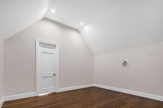 additional living space featuring lofted ceiling and hardwood / wood-style floors