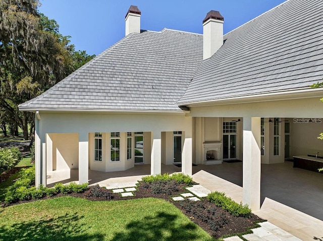 back of house featuring a yard and a patio area