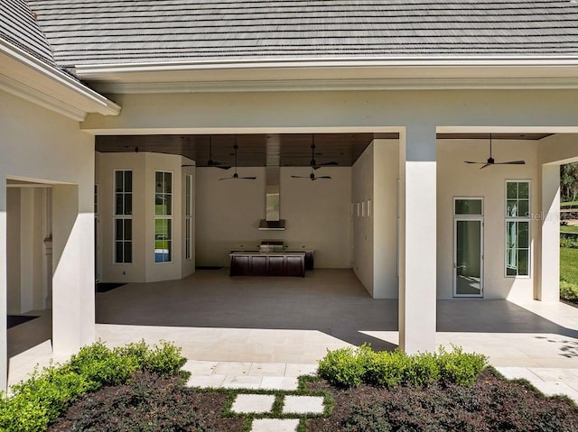 entrance to property featuring a patio and ceiling fan