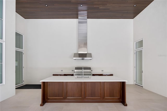 unfurnished office featuring wooden ceiling, a high ceiling, and light tile floors