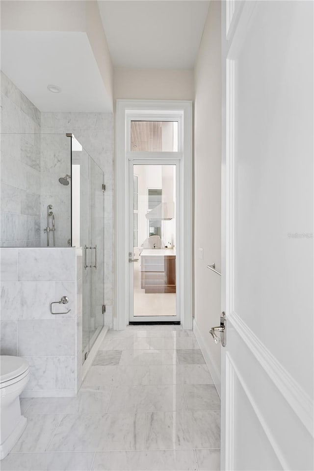 bathroom featuring walk in shower, tile floors, and toilet