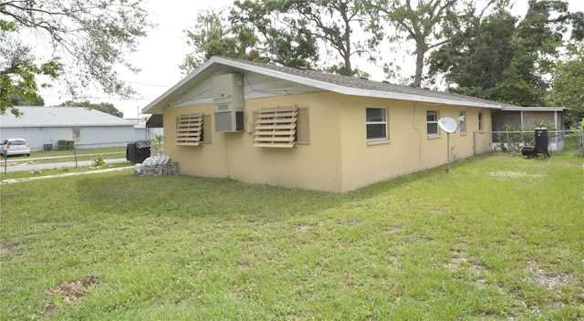 view of side of home with a yard