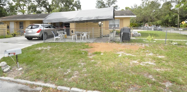 single story home featuring a carport and a front yard