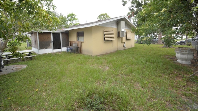 back of house with a lawn