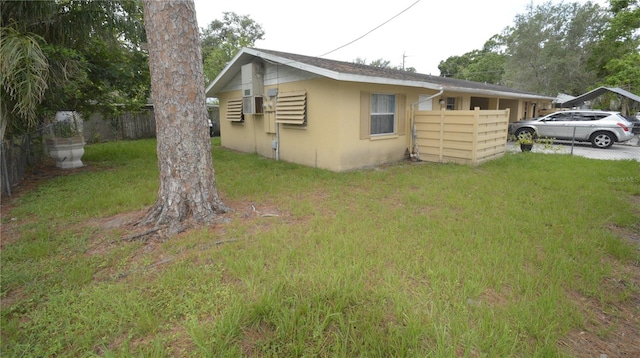 view of side of home featuring a lawn