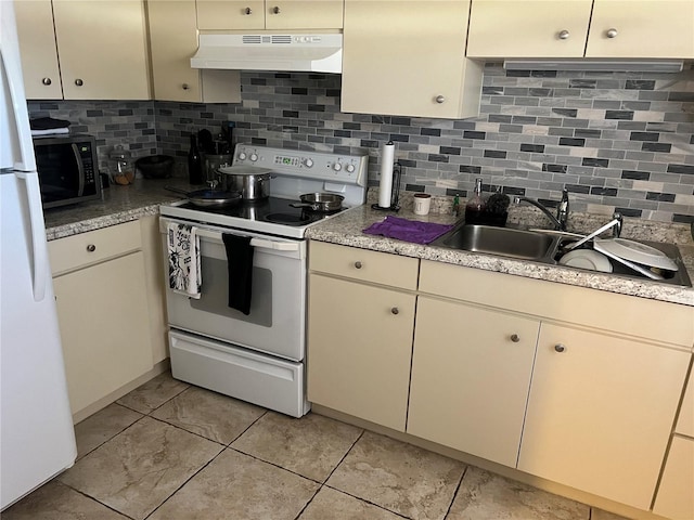 kitchen with white appliances, backsplash, sink, and cream cabinetry