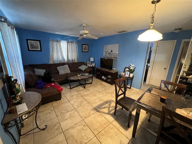 tiled living room with a textured ceiling and ceiling fan