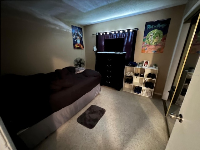 carpeted bedroom featuring a textured ceiling