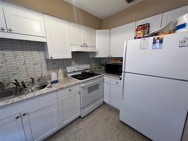 kitchen with white appliances, white cabinets, and decorative backsplash