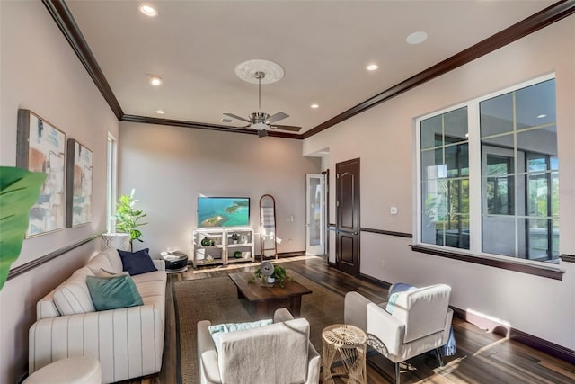 living room with ornamental molding, ceiling fan, and dark hardwood / wood-style flooring