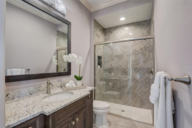 bathroom featuring crown molding, vanity, toilet, and a shower with shower door