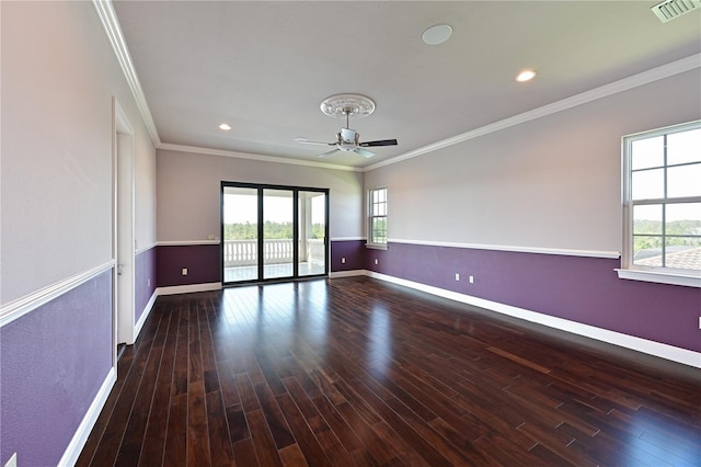 empty room with ornamental molding, ceiling fan, and dark hardwood / wood-style floors