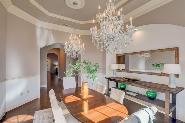 dining space with crown molding, dark hardwood / wood-style flooring, and a chandelier