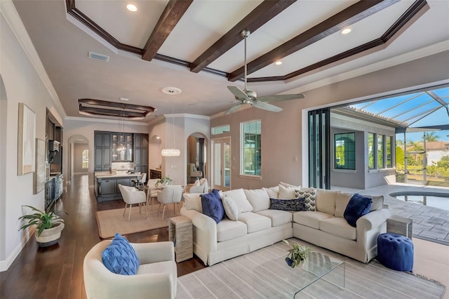 living room featuring dark hardwood / wood-style flooring, ceiling fan, and plenty of natural light