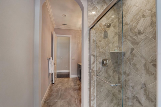 bathroom featuring ornamental molding, vanity, and a shower with shower door