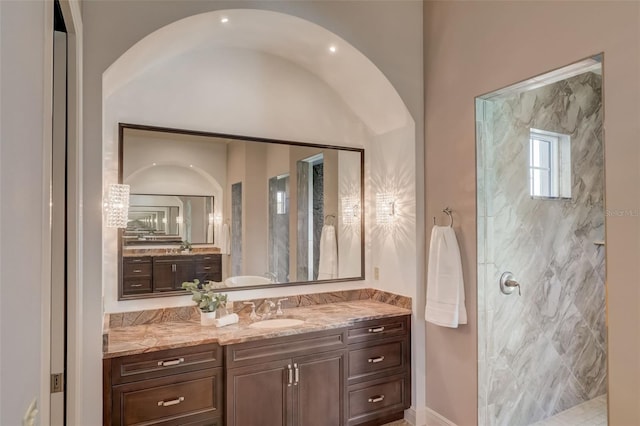 bathroom featuring vanity and tiled shower