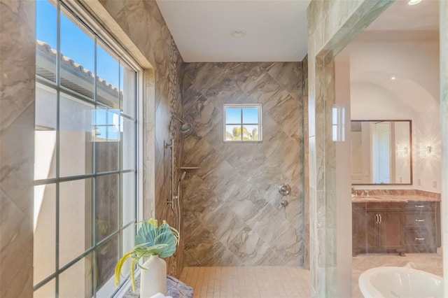 bathroom featuring independent shower and bath, vanity, tile walls, and tile patterned floors